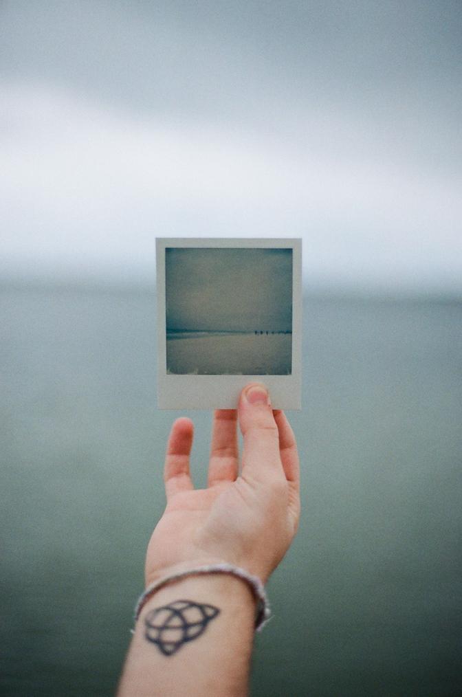 A polaroid photo with the ocean in the background